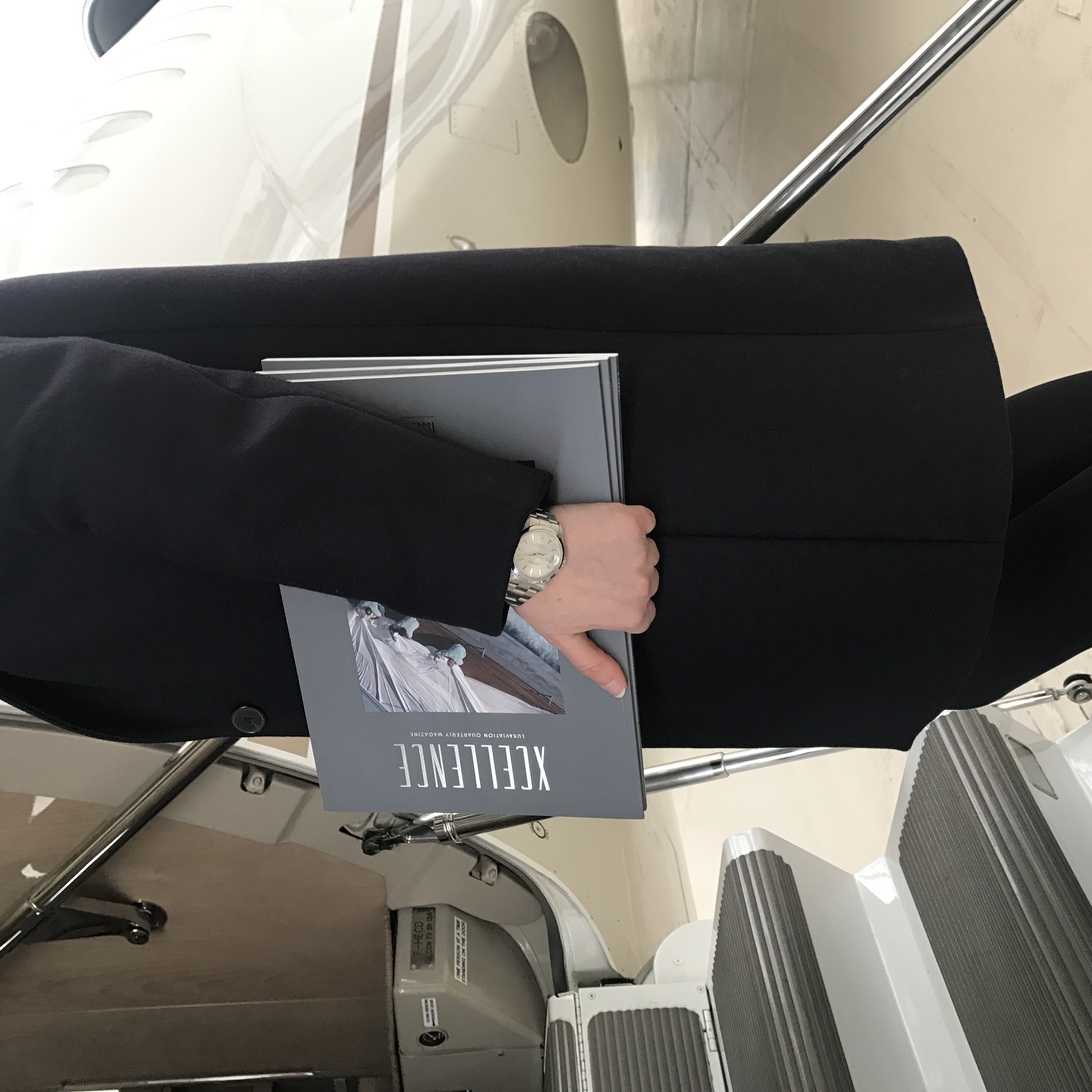Hands reviewing luxury magazine layout showing editorial integrity luxury publications in print production